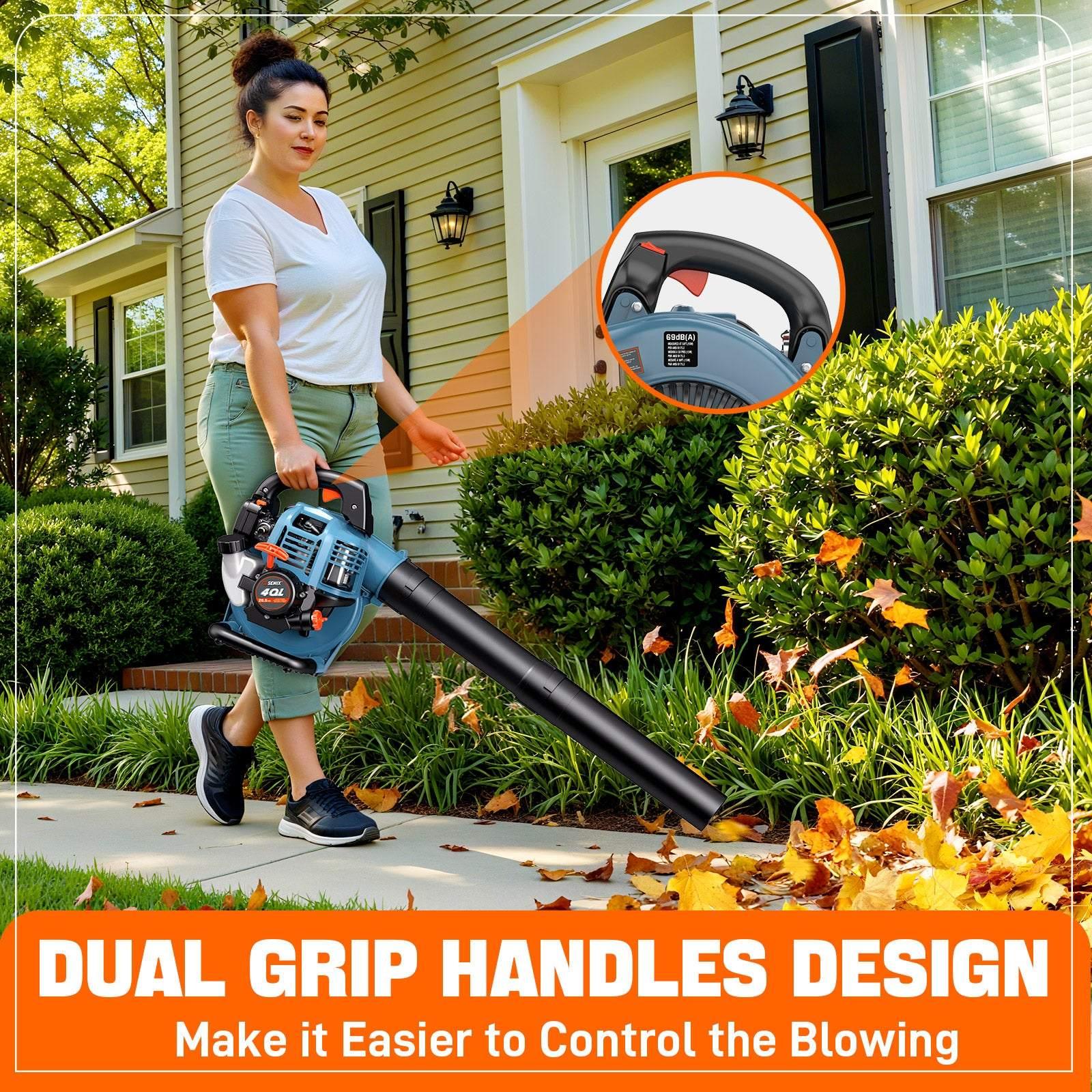 Woman using a blue gas-powered leaf blower with dual grip handles to clear fallen leaves from a sidewalk